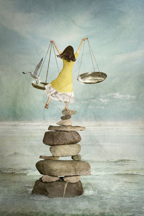 LO STRESS E I SISTEMI DI ADATTAMENTO FISIOLOGICI: una giovane donna è in equilibrio, su un piede solo, su una torre di pietre. Tiene due piatti in mano. Sul sinistro un gabbiano.